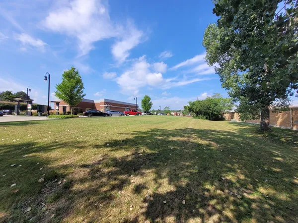 a view of yard with swimming pool and green space