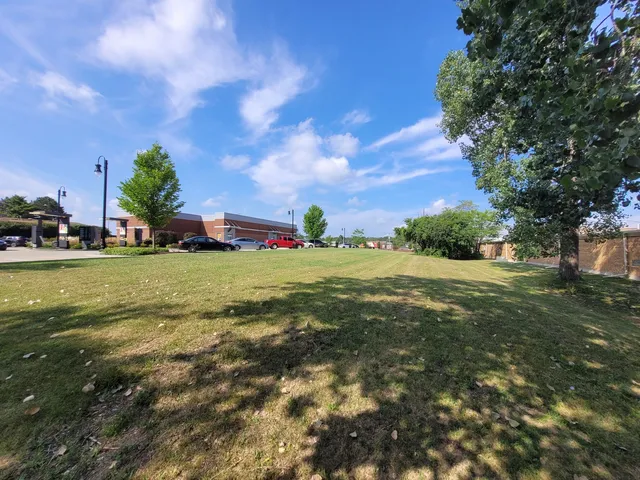 a view of yard with swimming pool and green space