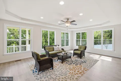 a living room with furniture and large windows