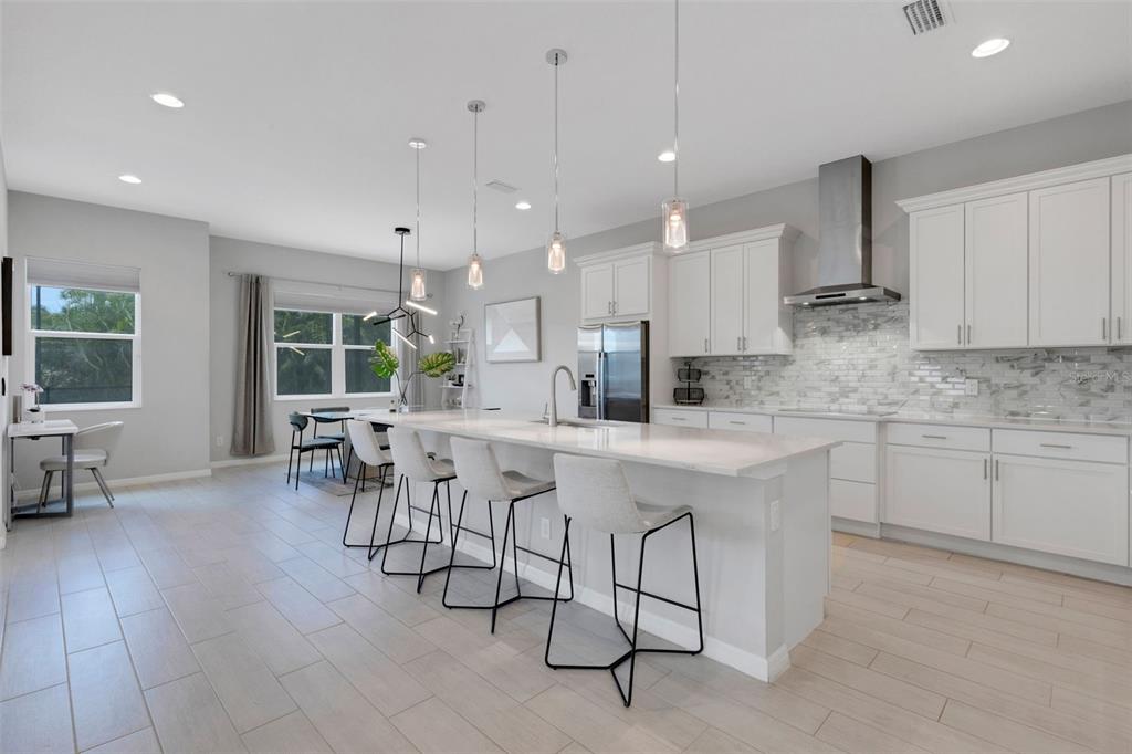 5718 Title Row Drive Bradenton, FL 34210 - Photo 29 of 74 a kitchen with stainless steel appliances kitchen island granite countertop a sink and cabinets