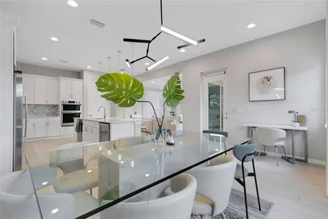 a bathroom with a sink a toilet a large mirror and shower