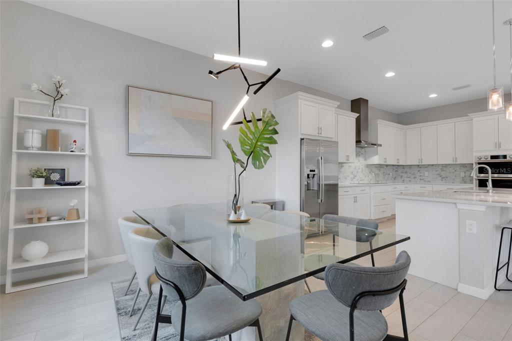 5718 Title Row Drive Bradenton, FL 34210 - Photo 34 of 74 a kitchen with a table and chairs in it