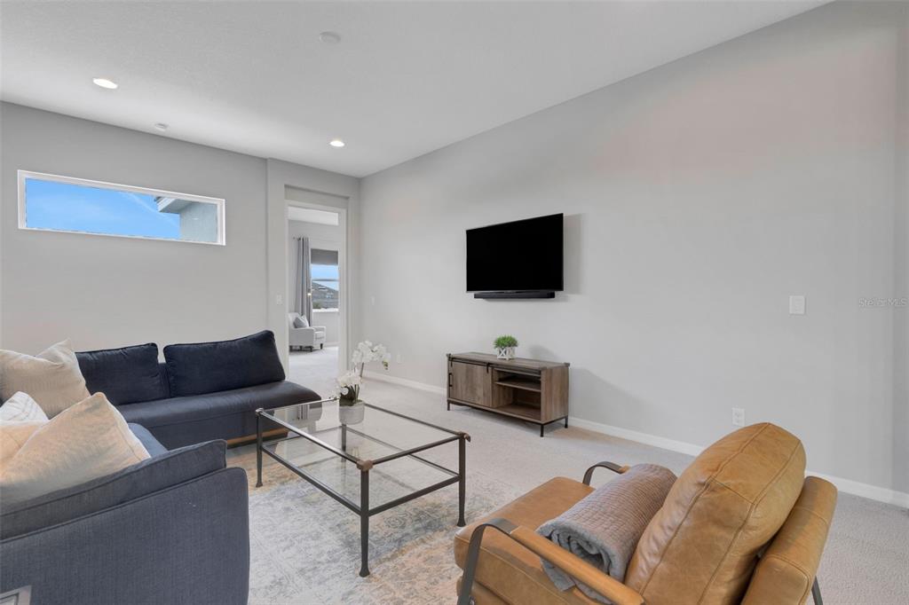 5718 Title Row Drive Bradenton, FL 34210 - Photo 59 of 74 a living room with furniture and a flat screen tv