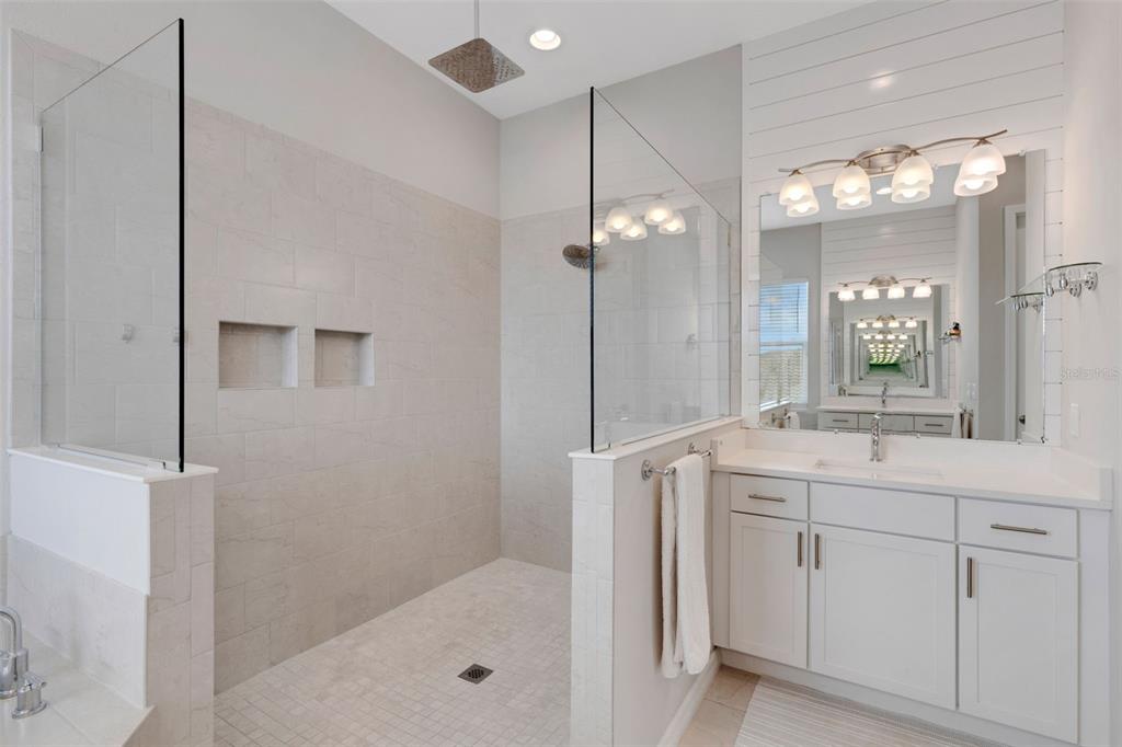 5718 Title Row Drive Bradenton, FL 34210 - Photo 66 of 74 a bathroom with a shower sink vanity and mirror