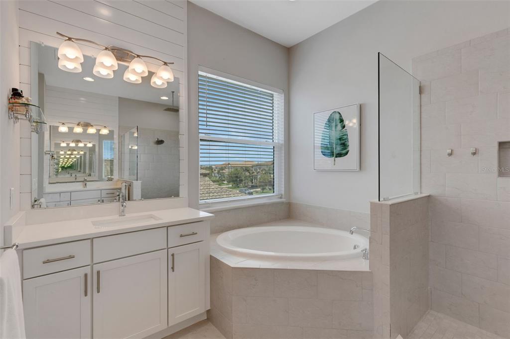 5718 Title Row Drive Bradenton, FL 34210 - Photo 67 of 74 a bathroom with a sink a toilet a large mirror and shower