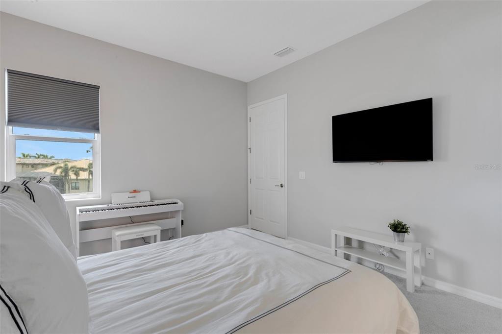 5718 Title Row Drive Bradenton, FL 34210 - Photo 70 of 74 a bedroom with a bed and a flat screen tv