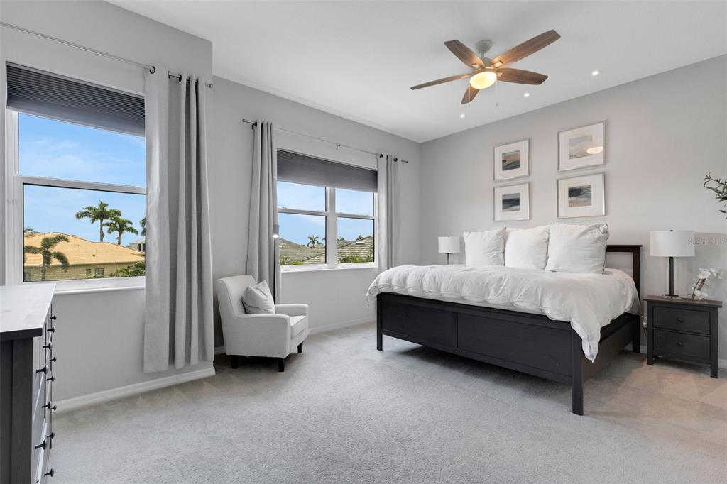 5718 Title Row Drive Bradenton, FL 34210 - Photo 7 of 74 a bedroom with a bed chandelier and a window