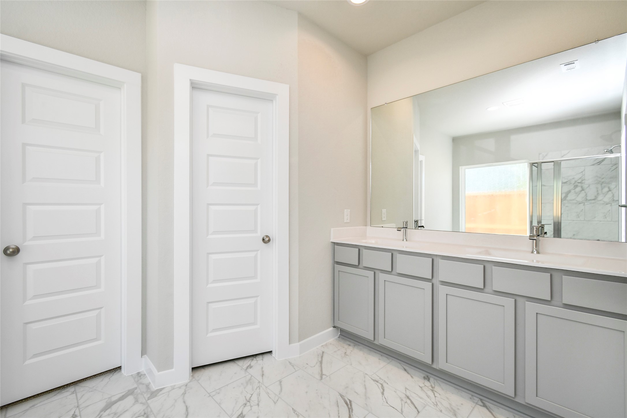 15111 Statice Trail Houston, TX 77044 - Photo 21 of 35 Escape to a spa-like oasis in this primary bathroom. Enjoy a walk-in shower with tile surround, a separate garden tub with custom detailing, and an elegant vanity featuring light countertops, modern hardware, and bright recessed lights. Experience luxury and relaxation in every detail. Sample photo of completed home with similar floor plan. Actual colors and selections may vary.