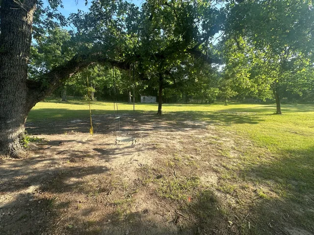 a view of a swimming pool with a yard