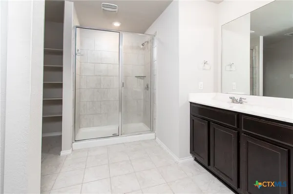 a bathroom with a shower and a sink