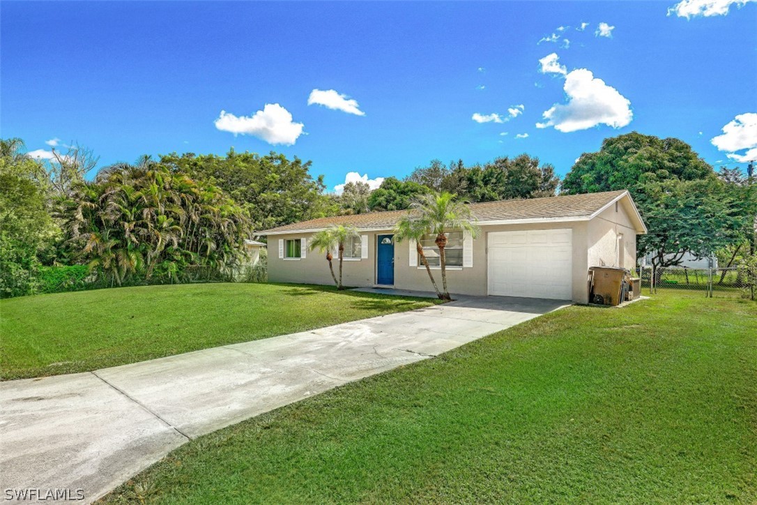 2310 Caladium Road Fort Myers, FL 33905 - Photo 1 of 31 a front view of a house with a garden and yard