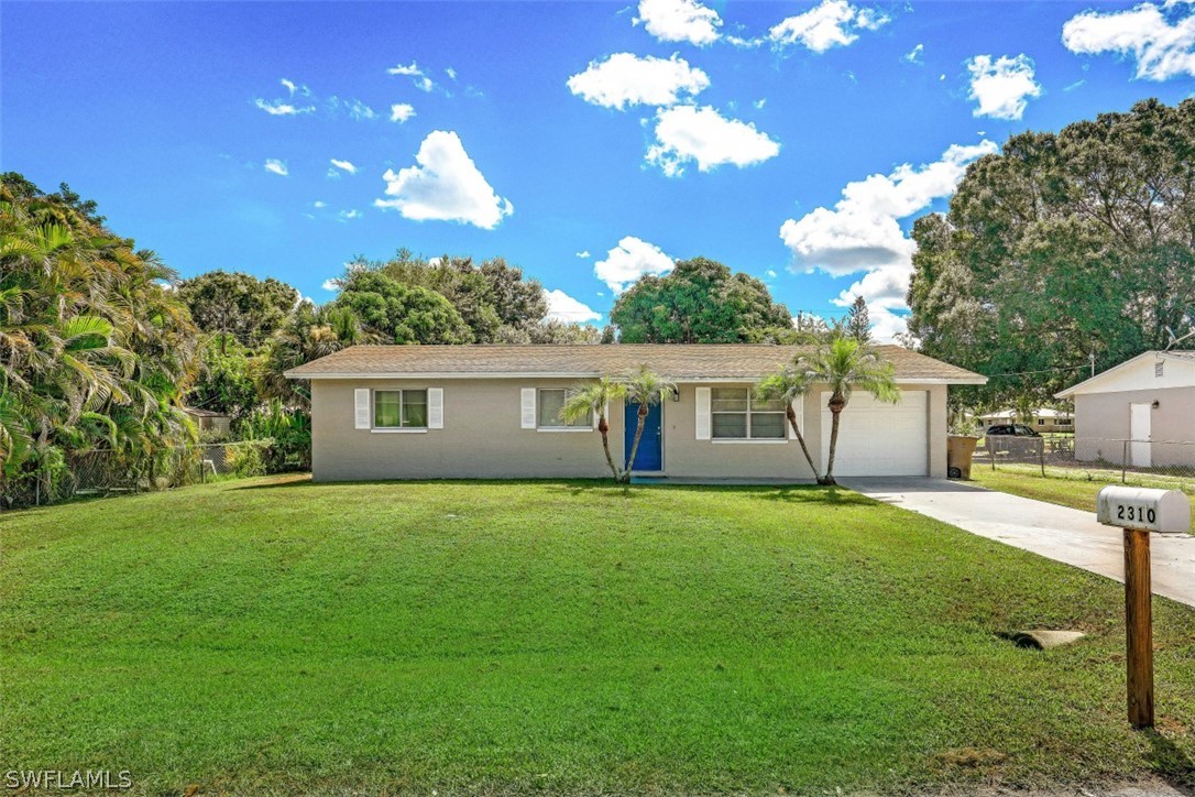 2310 Caladium Road Fort Myers, FL 33905 - Photo 2 of 31 a front view of a house with garden