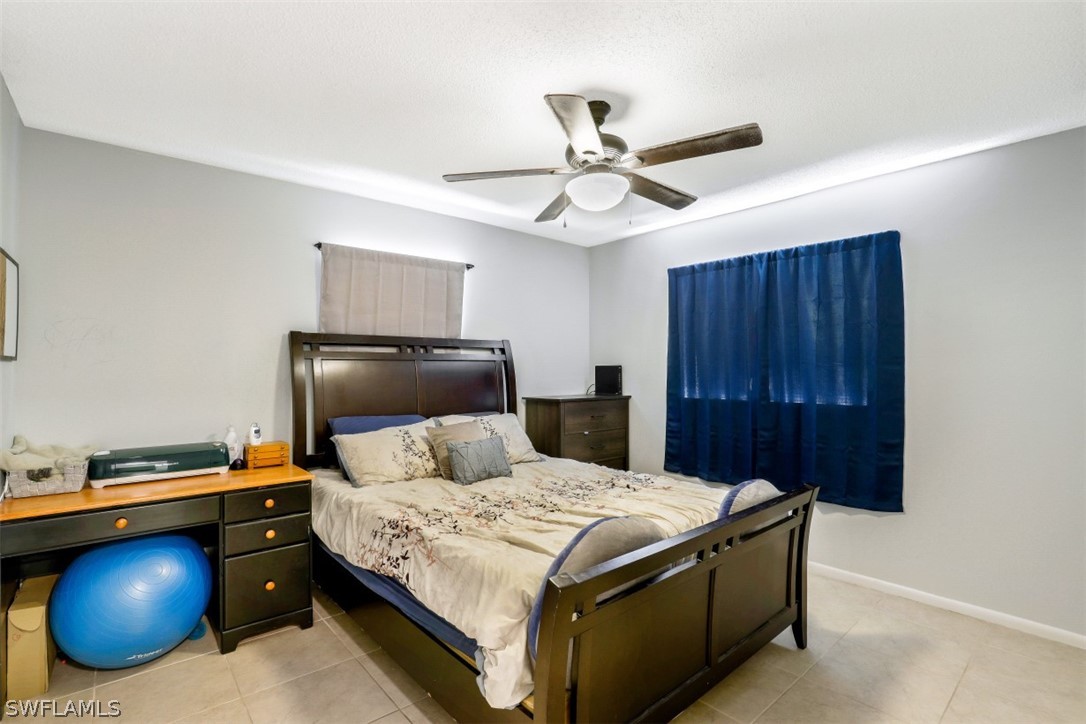 2310 Caladium Road Fort Myers, FL 33905 - Photo 24 of 31 a bedroom with a bed and a chandelier