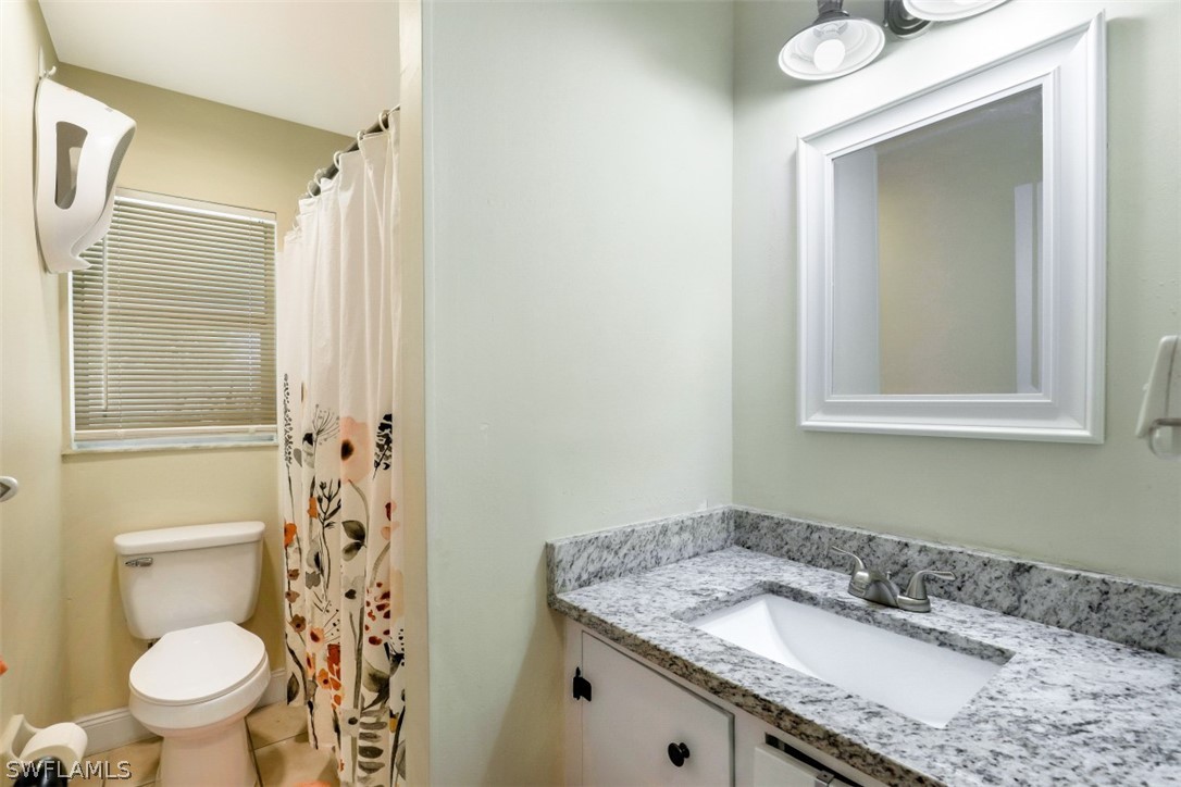 2310 Caladium Road Fort Myers, FL 33905 - Photo 26 of 31 a bathroom with a granite countertop sink toilet and shower