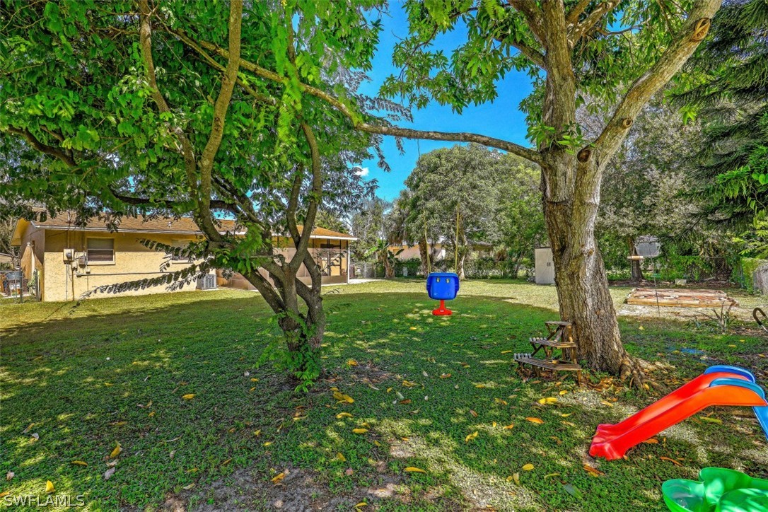 2310 Caladium Road Fort Myers, FL 33905 - Photo 8 of 31 a front view of a house with a yard