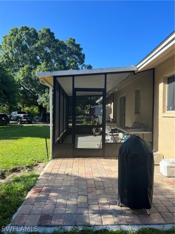 2310 Caladium Road Fort Myers, FL 33905 - Photo 9 of 31 a view of a patio with dining table and chairs with a yard
