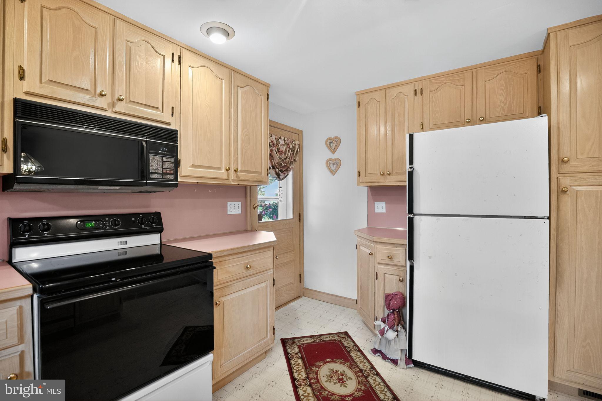 420 North Lewis Road Royersford, PA 19468 - Photo 11 of 28 a kitchen with stainless steel appliances a refrigerator stove and microwave