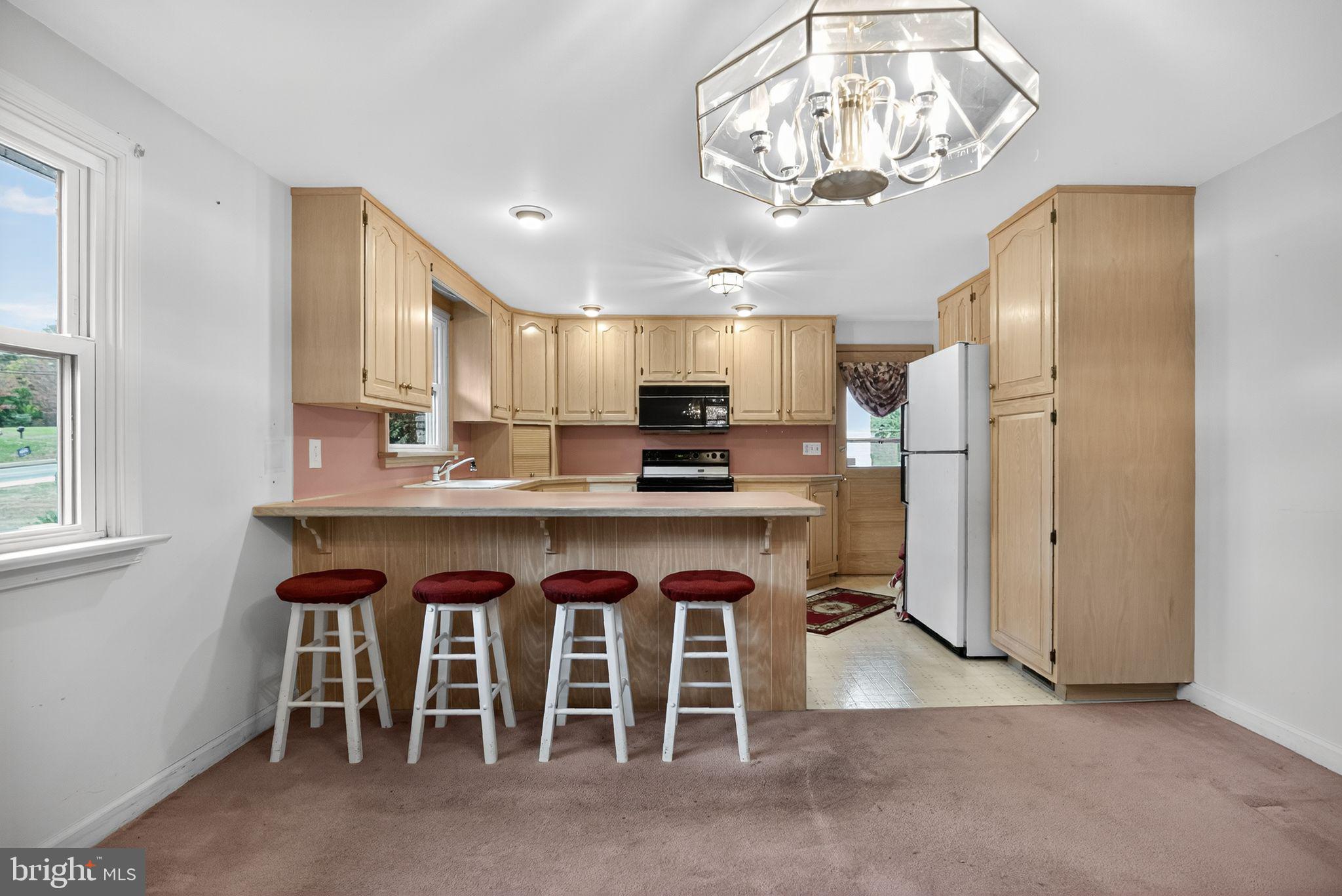 420 North Lewis Road Royersford, PA 19468 - Photo 7 of 28 a kitchen with stainless steel appliances granite countertop a refrigerator a stove a sink and a dining table with wooden floor