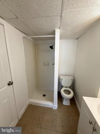 a bathroom with a toilet and a shower