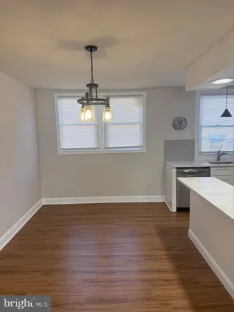 a view of a kitchen with a sink wooden floor and a window
