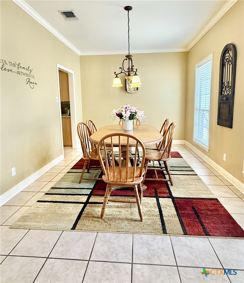415 South Trinity Street Edna, TX 77957 - Photo 11 of 46 a view of a dining room with furniture and chandelier