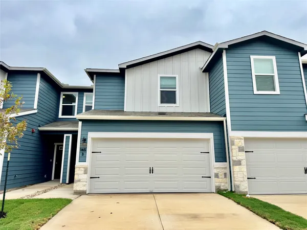 a front view of a house with a garage