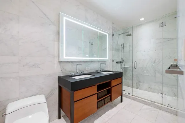 a bathroom with a tub shower and sink