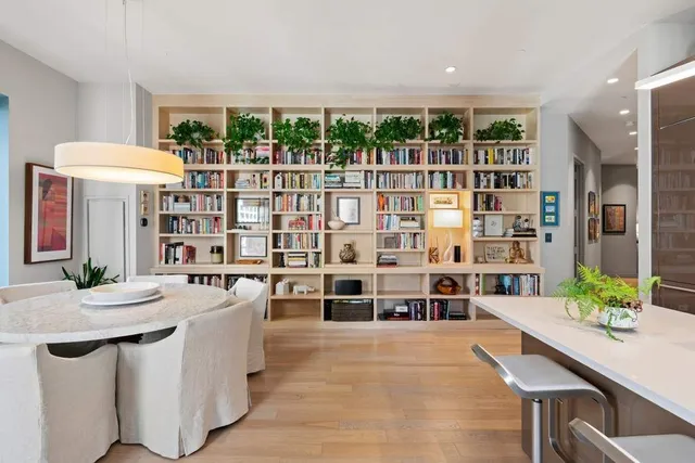 a kitchen with kitchen island a stove a table and chairs in it
