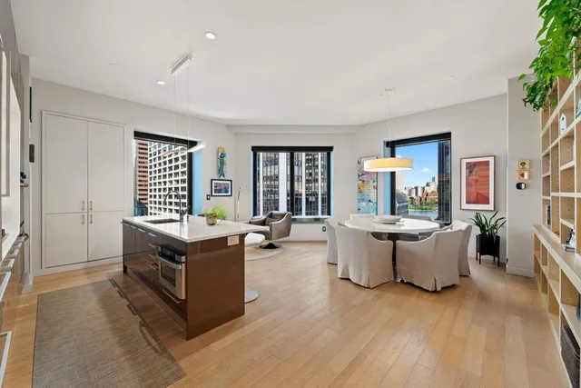 a kitchen with a large counter top appliances and living room