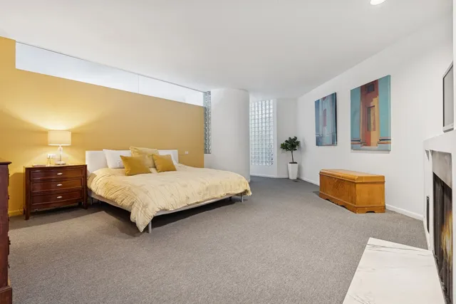 a bedroom with a bed and a night stand