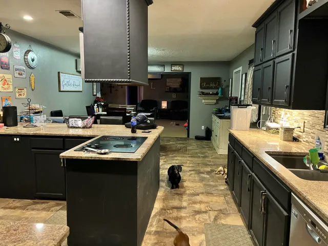 a kitchen with a sink stove and cabinets