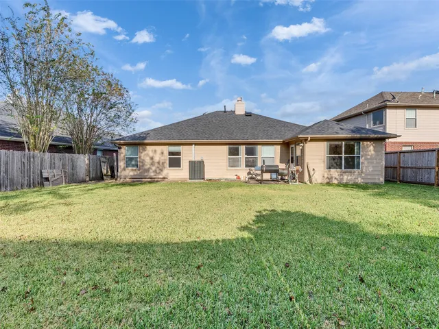 a front view of a house with a yard table and chairs