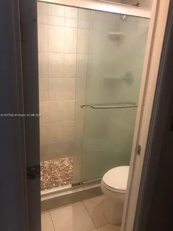a bathroom with a toilet and a shower