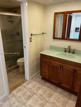 a bedroom with a bed and a flat tv screen on dresser