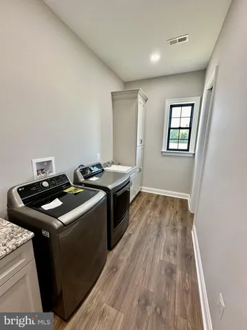 a bathroom with a granite countertop sink a mirror and shower