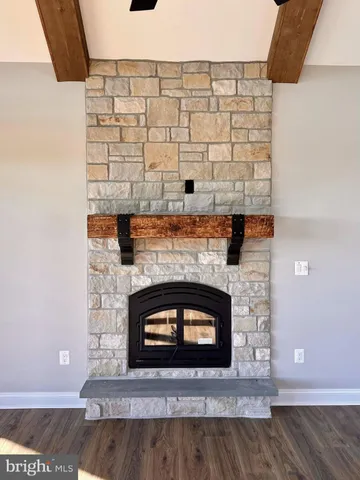 a large kitchen with stainless steel appliances a large counter top a stove and a wooden floors