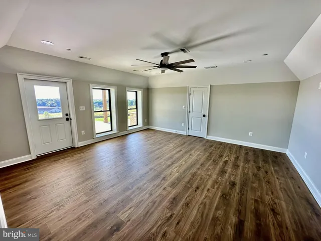 a large kitchen with stainless steel appliances granite countertop a sink a stove and a wooden floors