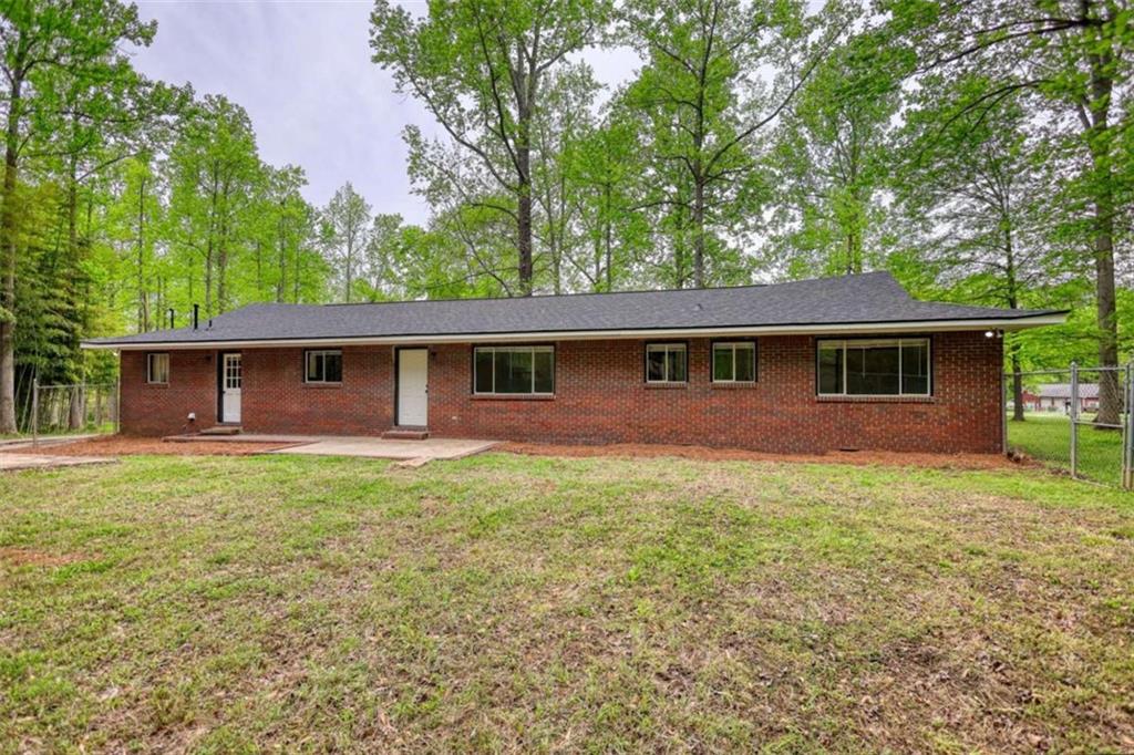 555 Joy Street Jackson, GA 30233 - Photo 4 of 56 front view of a house with a yard