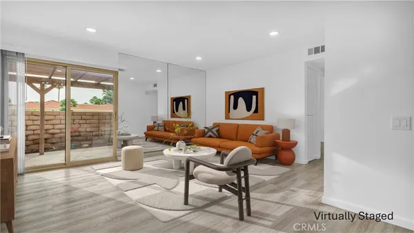 a living room with furniture and a floor to ceiling window
