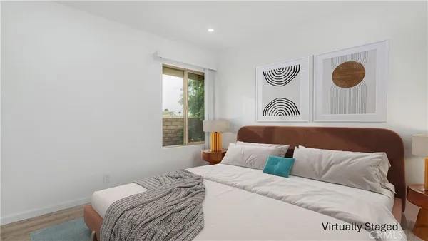 a bedroom with a bed and painting on the wall