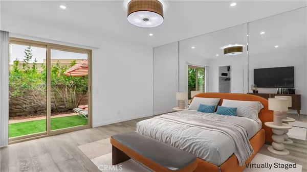a spacious bedroom with a bed and glass door