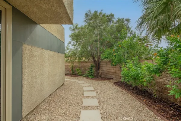 a view of a pathway both side of house