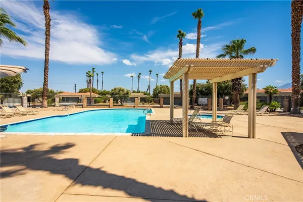 a view of a swimming pool with a table and chairs