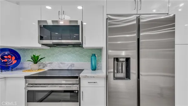 a kitchen with a refrigerator and a stove
