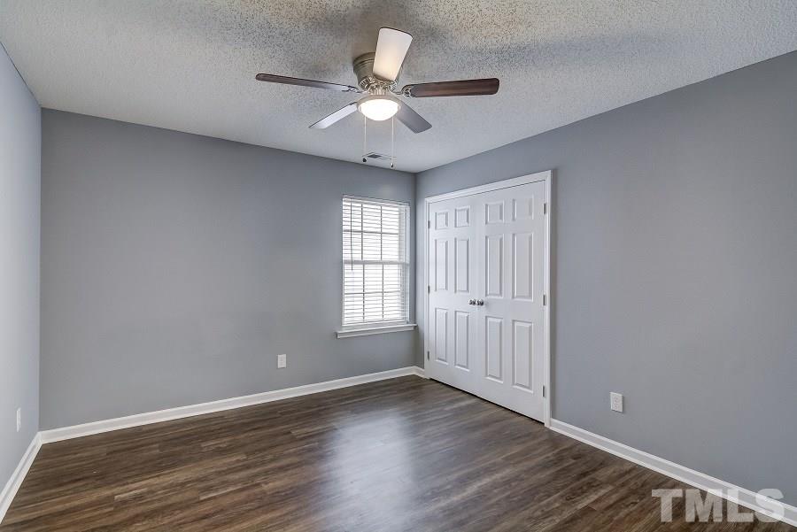 3323 Marcony Way Raleigh, NC 27610 - Photo 11 of 14 a view of an empty room with wooden floor and a window