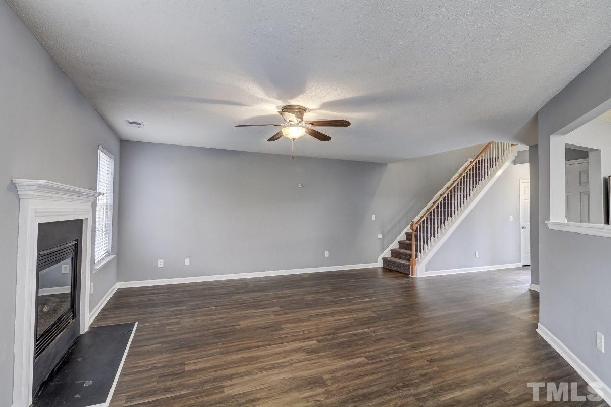 3323 Marcony Way Raleigh, NC 27610 - Photo 3 of 14 a view of an empty room with wooden floor and a ceiling fan