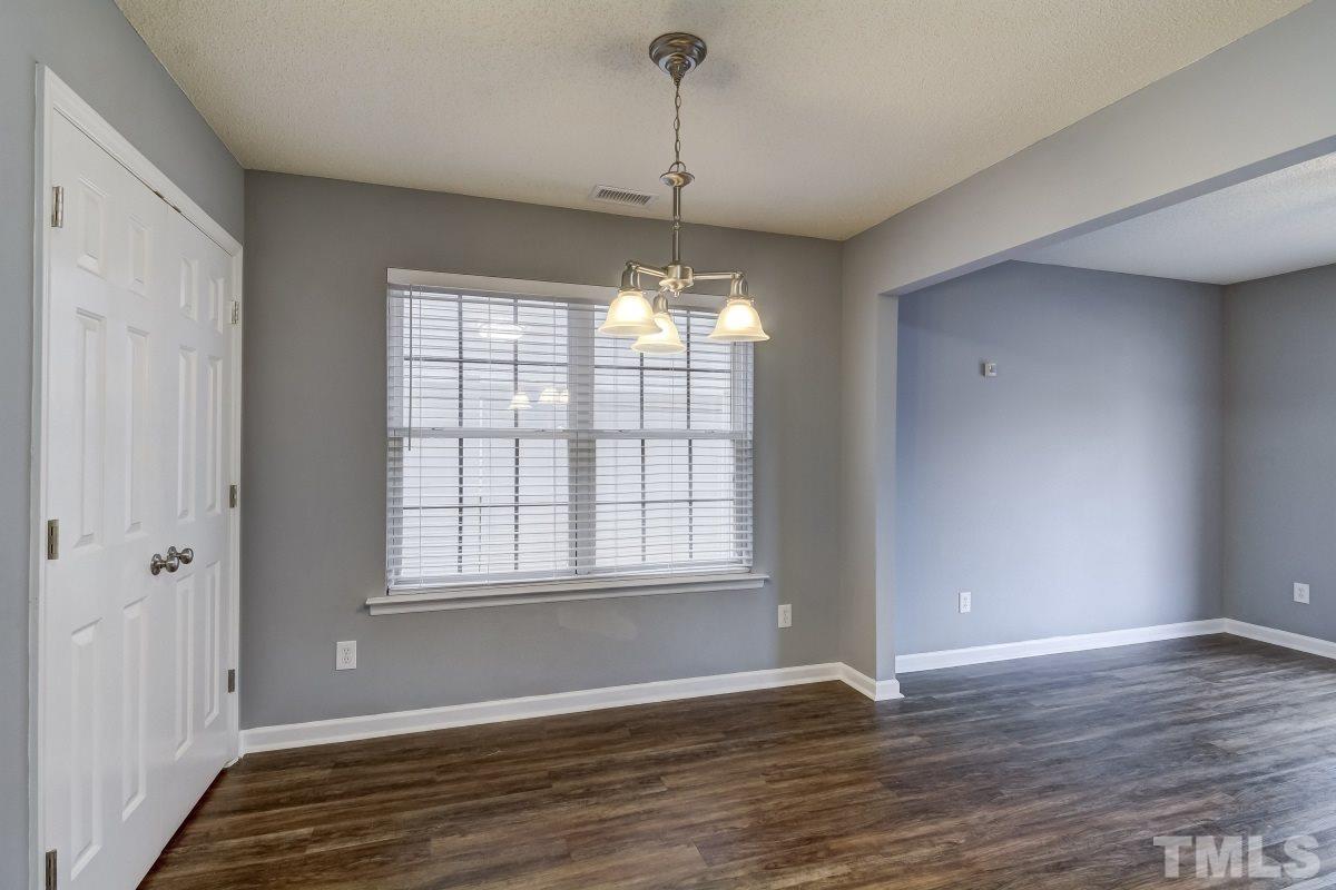 3323 Marcony Way Raleigh, NC 27610 - Photo 6 of 14 a view of an empty room with wooden floor and a window