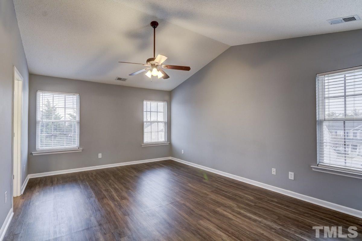 3323 Marcony Way Raleigh, NC 27610 - Photo 7 of 14 a view of an empty room with wooden floor and a window