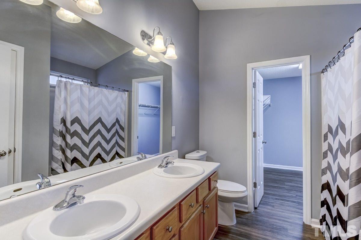 3323 Marcony Way Raleigh, NC 27610 - Photo 8 of 14 a bathroom with a sink double vanity and a mirror