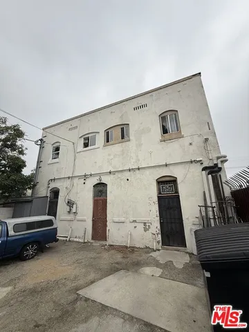 a view of a house with a wooden fence